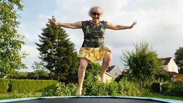 A woman bouncing on a trampoline