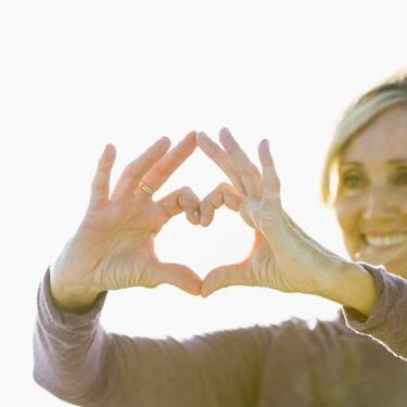 Woman holding heart symbol in hands
