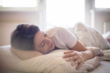 Woman sleeping nothing better than a lie in