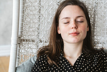 Young woman meditating sitting peaceful mindful