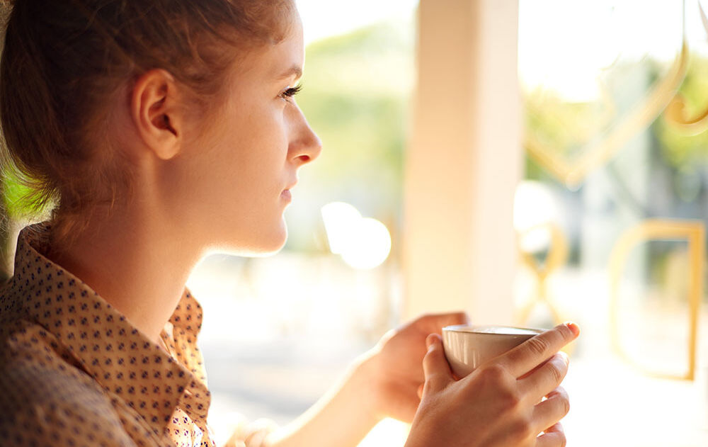 Young woman worried cup of tea