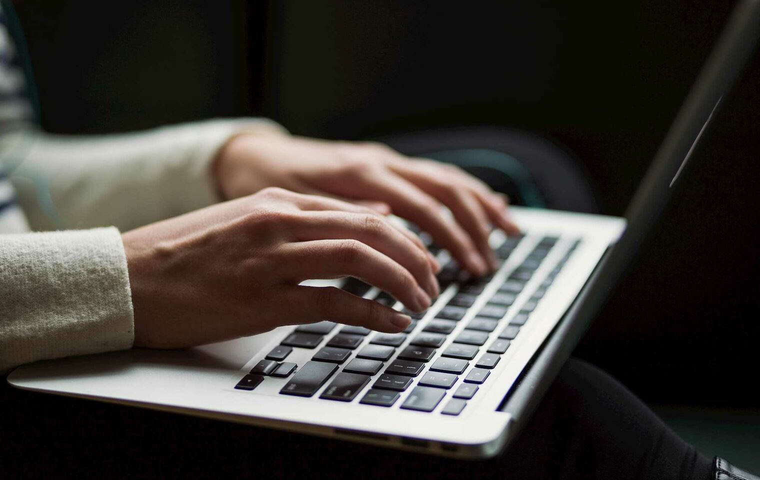 Woman typing laptop keyboard