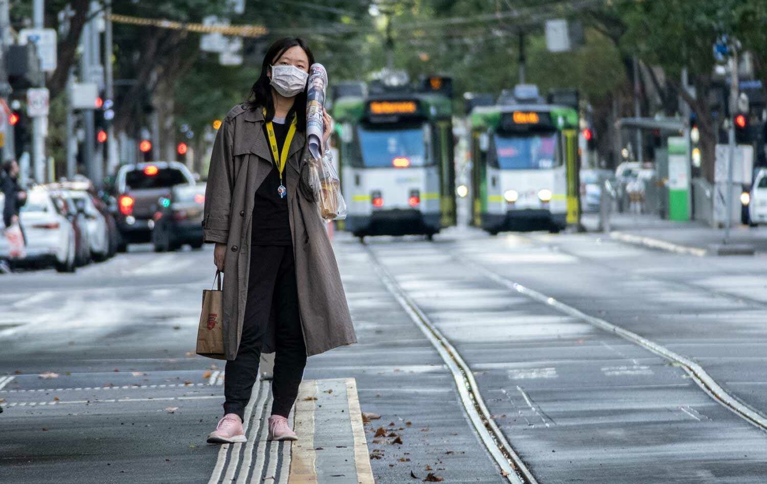 Melbourne woman waiting tram pandemic