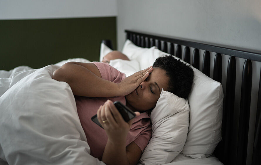 Woman feeling stressed out in bed