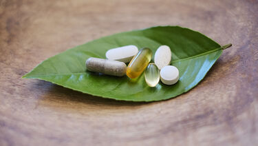 Pills and capsules on leaf