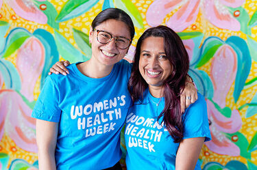 Two women hugging in Women's Health Week t-shirts