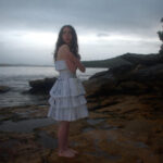 Lotte Weber standing by the ocean