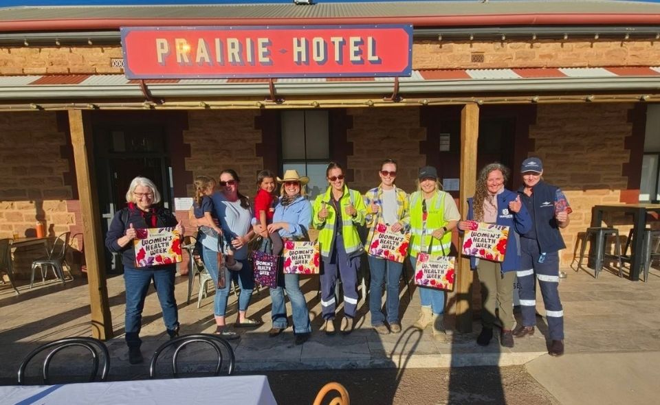 Renea with a group of people outside the Prairie Hotel in Parachilna, South Australia