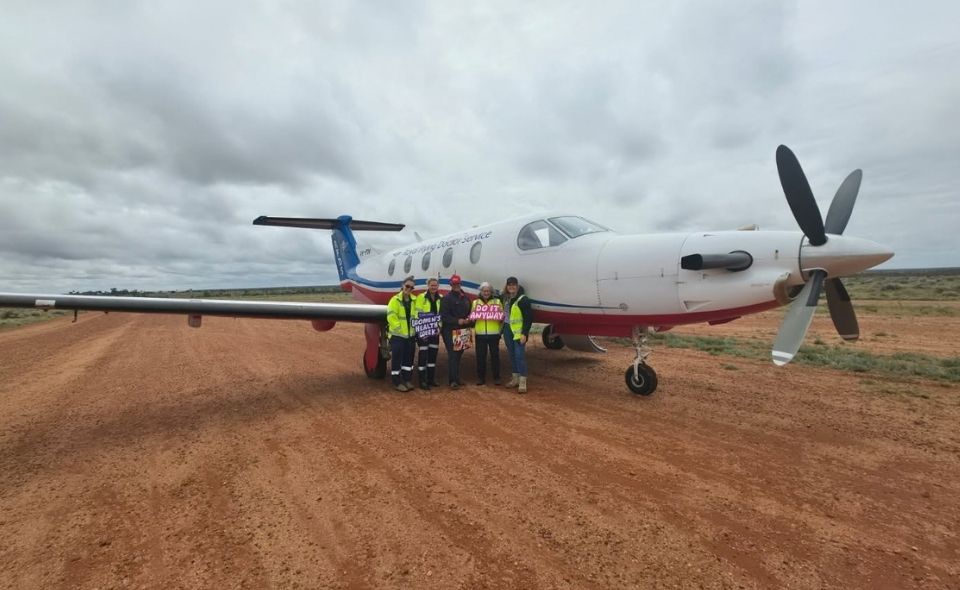 Renea with the RFDS Port Augusta-based crew standing in front of an RFDS plane at Commonwealth Hill