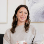 A smiling woman on a couch