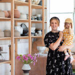 A photo of Kate Brouwer with her child in a cermiac studio